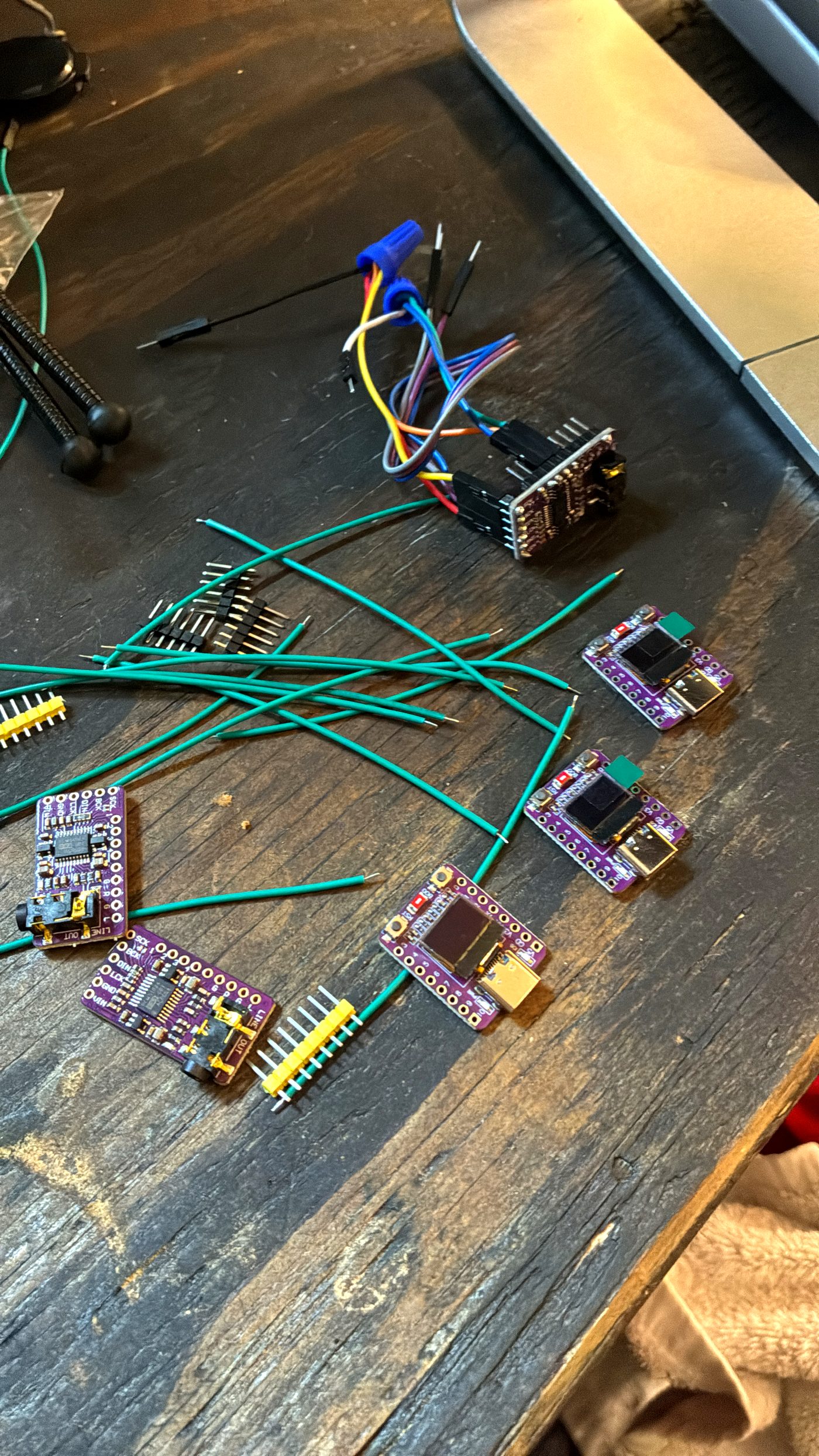 A workbench covered in StreamPuck boards, wires, and amp modules