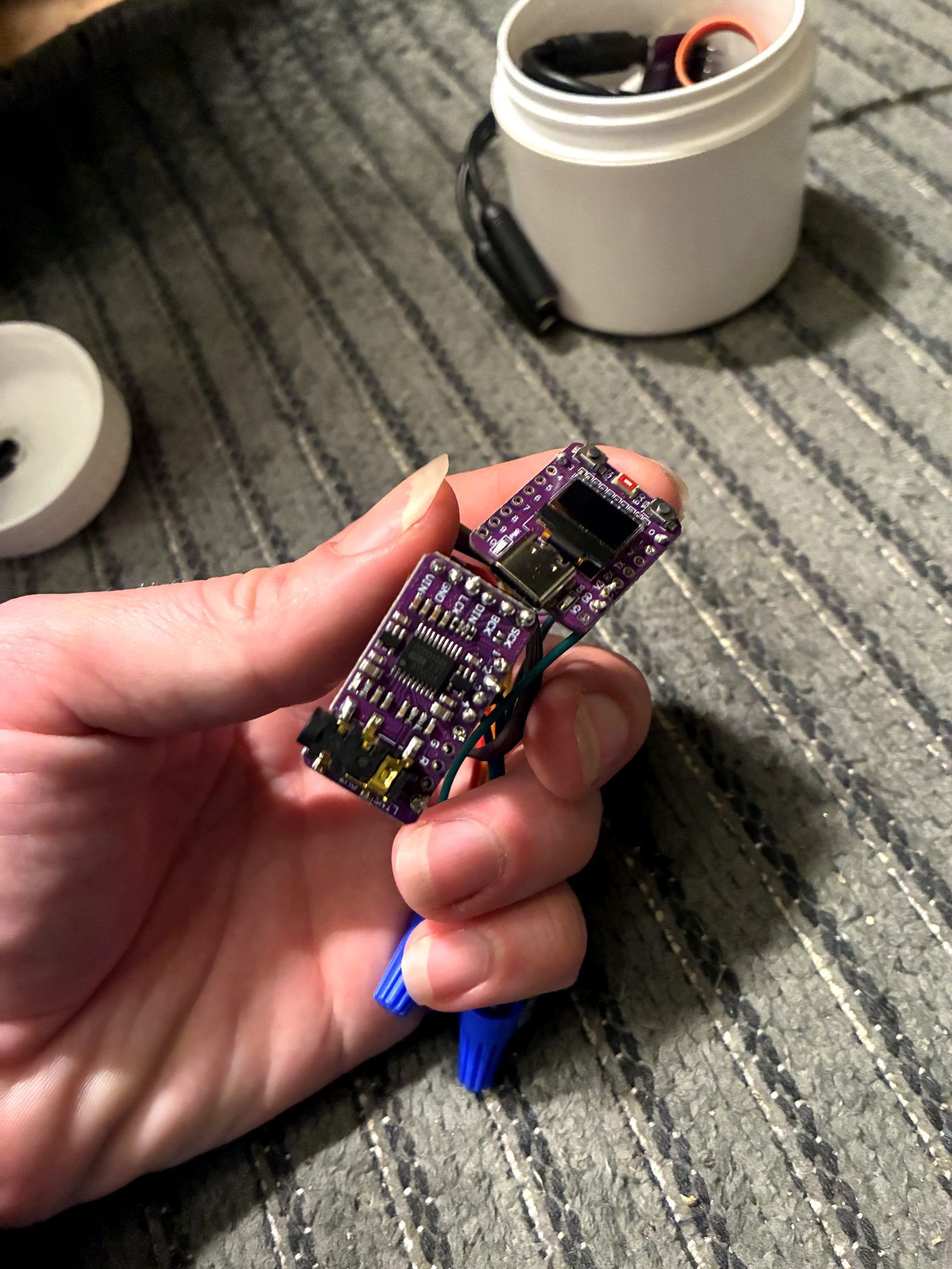 StreamPuck stacked with an amplifier board, held in hand