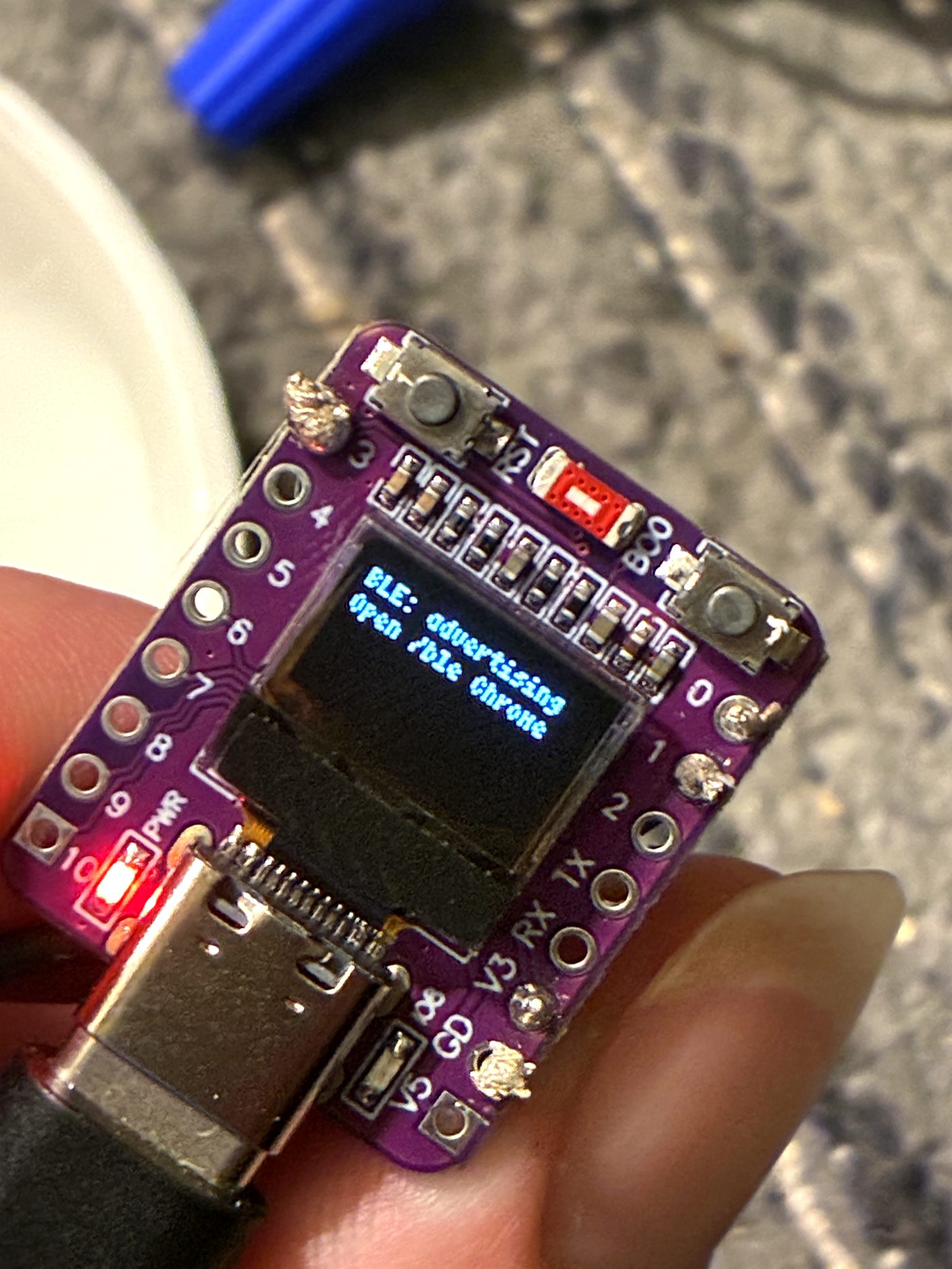 Macro of the first StreamPuck with its OLED lit up
